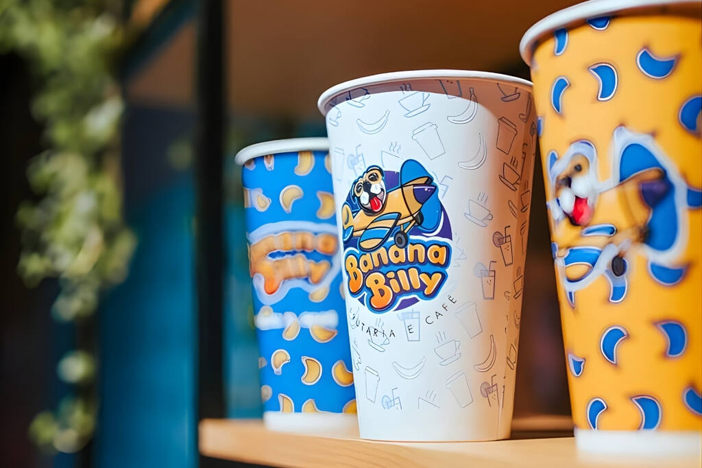 Copos de papel em pretaleira de cafeteria após a personalização de copos de papel com identidade visual da marca