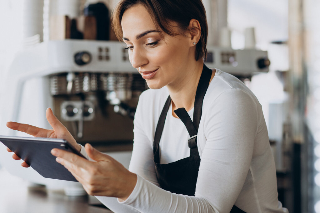 Mulher pesquisando sobre gestão de restaurante em tablet